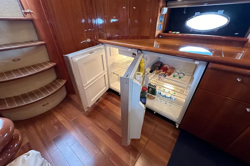 D Yacht Photos Pics Sunseeker Predator 60 yacht interior with open fridge, wooden flooring, and stairs, 2000 model.