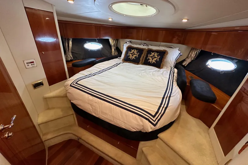 D Yacht Photos Pics Luxurious cabin interior of 2000 Sunseeker Predator 60 yacht with elegant bedding and wood finishes.