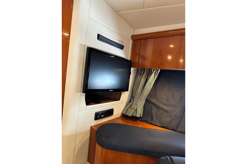 D Yacht Photos Pics Interior of 2000 Sunseeker Predator 60 yacht with TV and wood paneling.