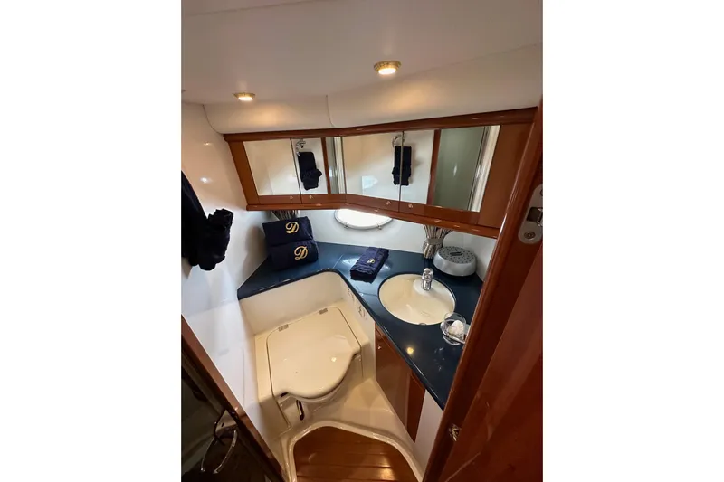 D Yacht Photos Pics Luxurious bathroom in 2000 Sunseeker Predator 60 yacht with elegant fixtures and wood accents.