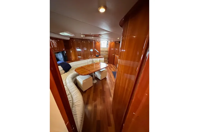 D Yacht Photos Pics Luxurious interior of 2000 Sunseeker Predator 60 yacht with wood finish and seating area.