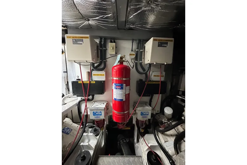 D Yacht Photos Pics Engine room of 2000 Sunseeker Predator 60 with fire extinguisher and control panels.