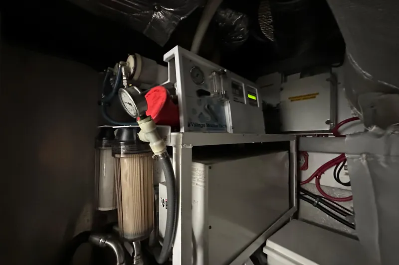 D Yacht Photos Pics Engine room of 2000 Sunseeker Predator 60 yacht, featuring mechanical equipment and gauges.