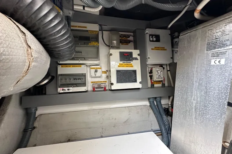 D Yacht Photos Pics Electrical panel inside a 2000 Sunseeker Predator 60 yacht, featuring circuit breakers and battery switches.