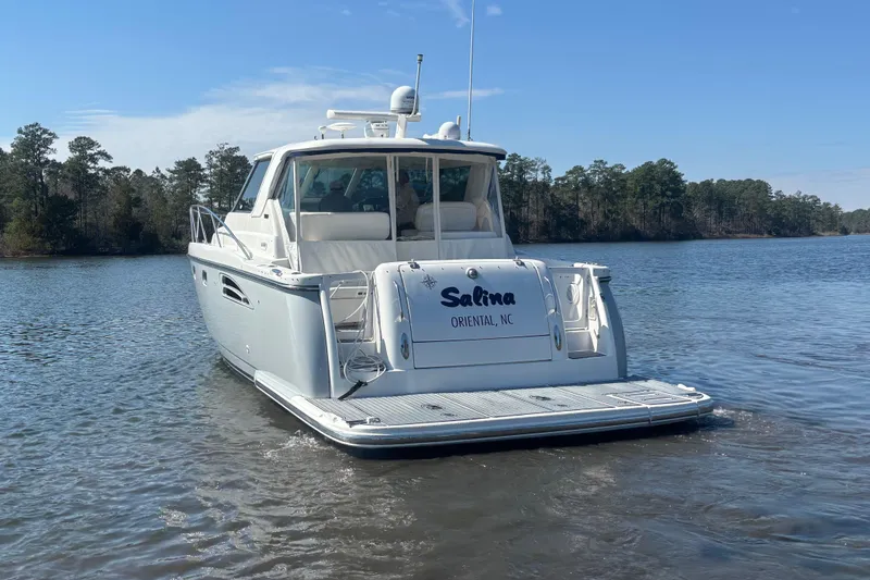 Salina Yacht Photos Pics 2004 Tiara Yachts 3600 Sovran on calm water, rear view with trees in background.