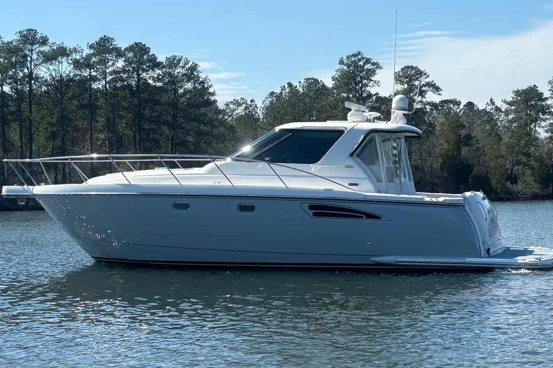 Salina Yacht Photos Pics 2004 Tiara Yachts 3600 Sovran cruising on a serene lake with forested background.