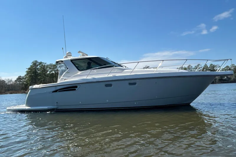 Salina Yacht Photos Pics 2004 Tiara Yachts 3600 Sovran cruising on a calm lake under a clear blue sky.