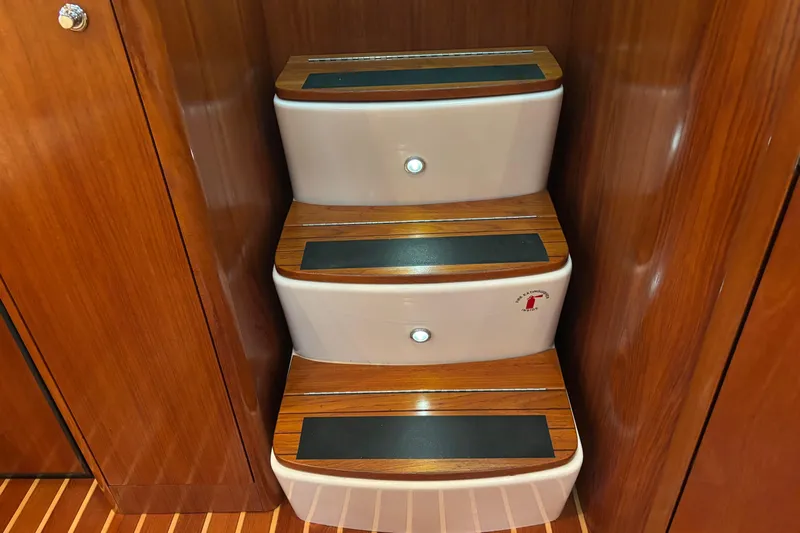 Salina Yacht Photos Pics Wooden steps inside a 2004 Tiara Yachts 3600 Sovran, featuring sleek design and lighting.