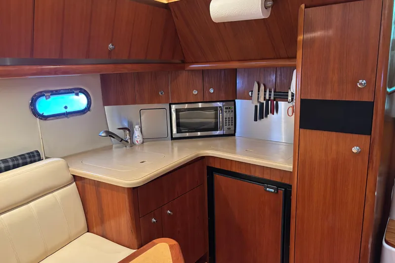 Salina Yacht Photos Pics 2004 Tiara Yachts 3600 Sovran galley with wood cabinetry, microwave, and sink.