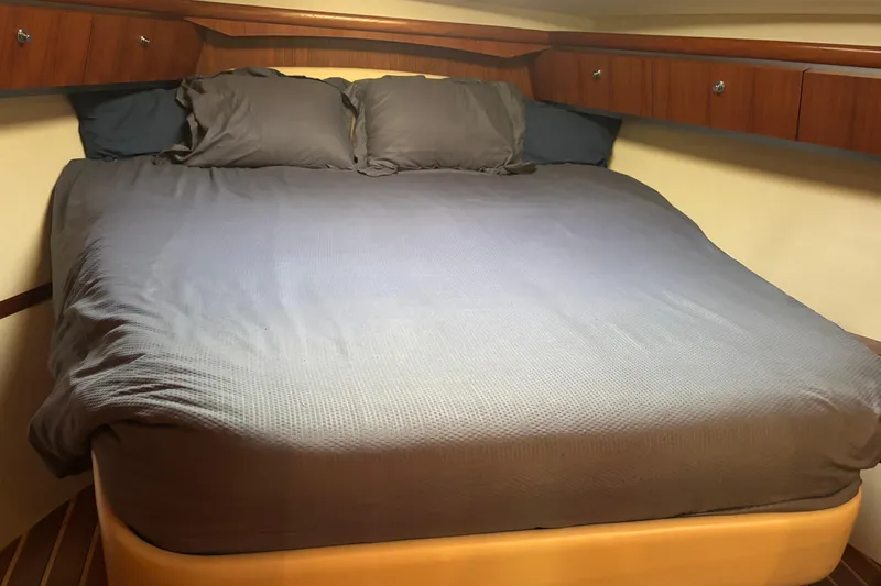 Salina Yacht Photos Pics Luxurious cabin interior of 2004 Tiara Yachts 3600 Sovran with cozy bed and wooden accents.