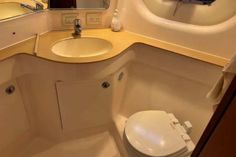 Salina Yacht Photos Pics 2004 Tiara Yachts 3600 Sovran bathroom with sink, toilet, and mirror.