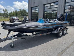 2023 Bass Cat Cougar FTD boat on trailer, parked outside a building.