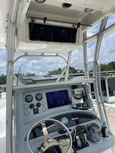  Yacht Photos Pics 2005 Boston Whaler 320 Outrage helm with navigation instruments and steering wheel.