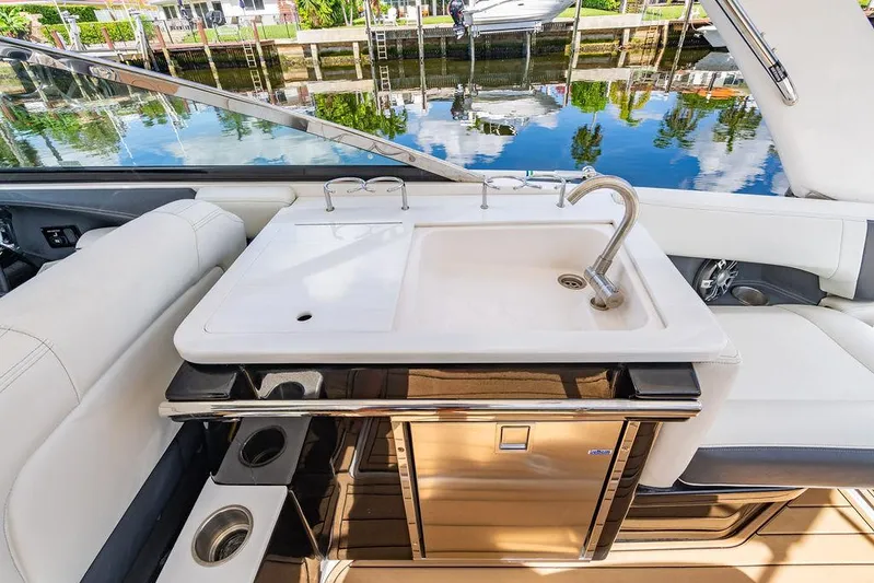 Dreamaker Yacht Photos Pics 2021 Regal 29 OBX boat interior with sink and seating area.