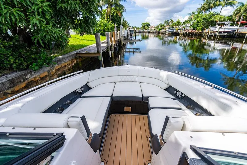 Dreamaker Yacht Photos Pics 2021 Regal 29 OBX boat with luxurious seating on a scenic waterway.