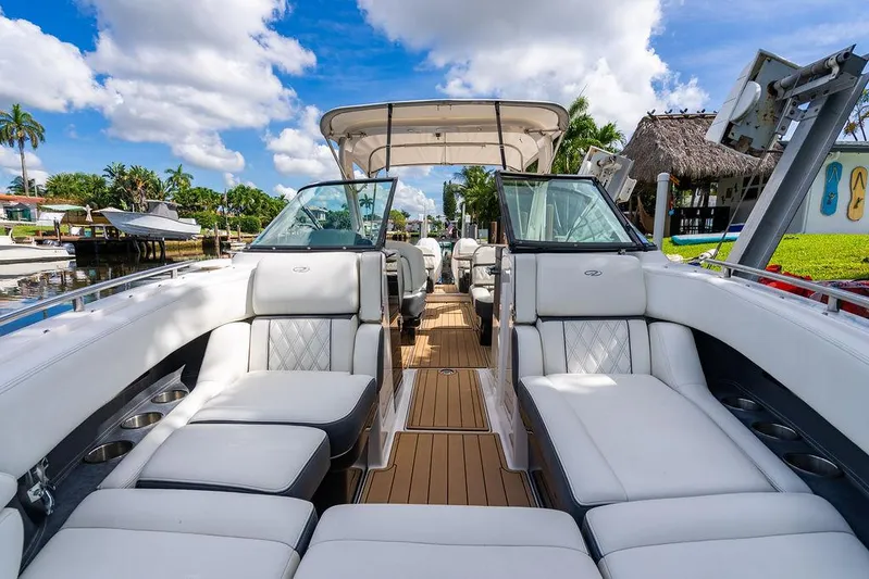 Dreamaker Yacht Photos Pics 2021 Regal 29 OBX boat with luxurious seating, docked under a sunny sky.