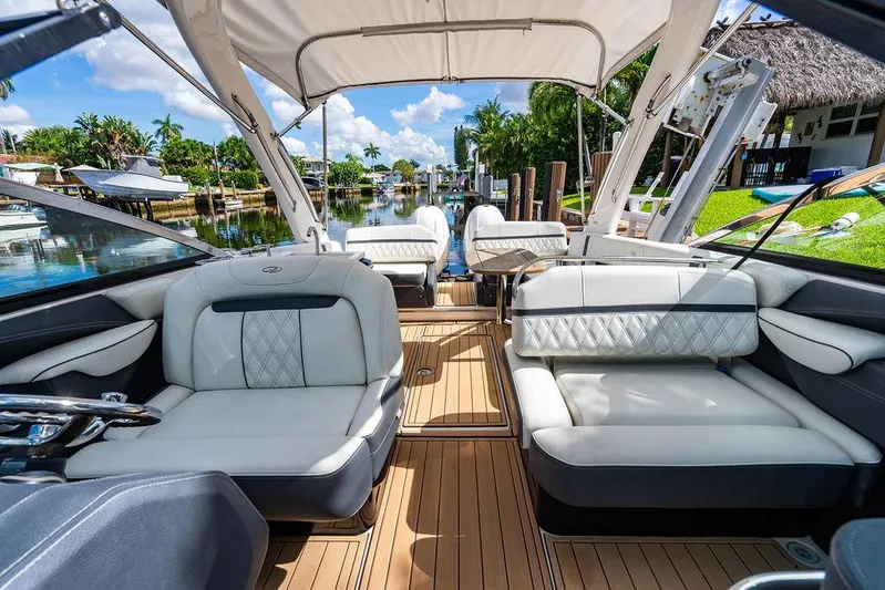 Dreamaker Yacht Photos Pics 2021 Regal 29 OBX boat interior with luxurious seating and scenic canal view.