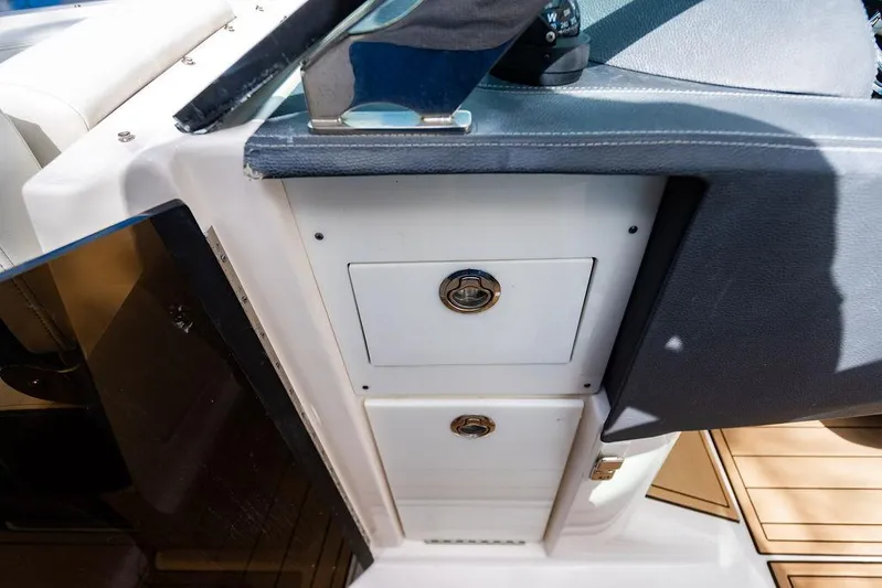 Dreamaker Yacht Photos Pics 2021 Regal 29 OBX boat interior with storage compartments and seating.