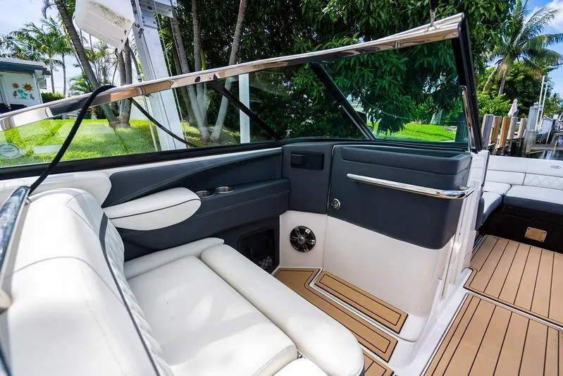 Dreamaker Yacht Photos Pics 2021 Regal 29 OBX boat interior with white seating and sleek design.