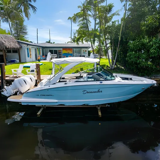 Dreamaker Yacht Photos Pics 2021 Regal 29 OBX boat named "Dreamaker" docked by a tropical waterfront home.