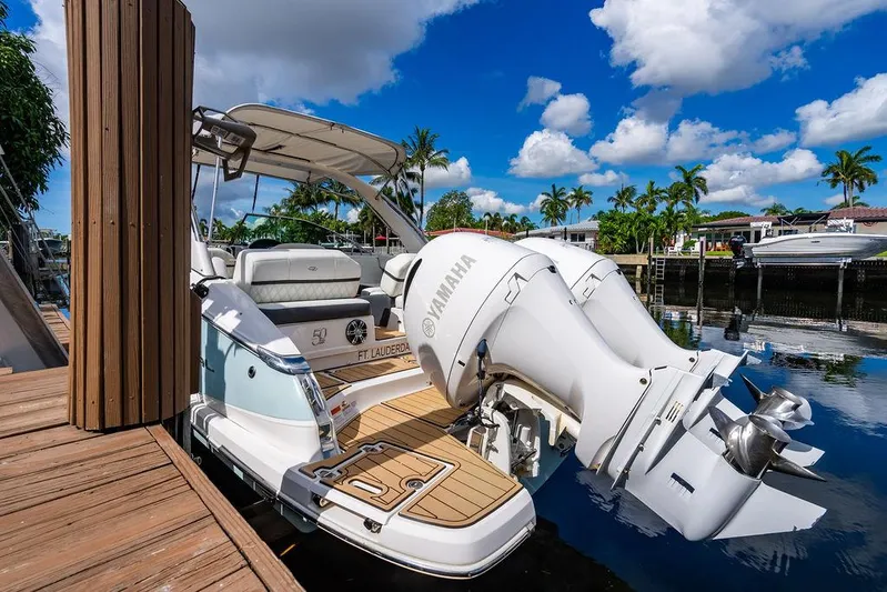 Dreamaker Yacht Photos Pics 2021 Regal 29 OBX boat docked, featuring Yamaha outboard engines, under a clear blue sky.