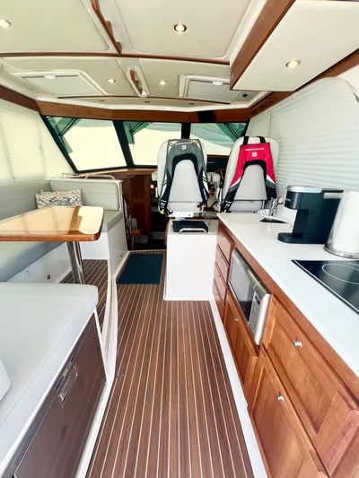 Risk & Reward Yacht Photos Pics 2022 Back Cove 39O yacht interior with modern kitchen and seating area.