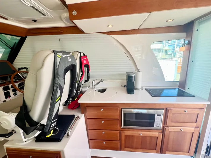 Risk & Reward Yacht Photos Pics Interior of 2022 Back Cove 39O yacht with kitchen and helm station.