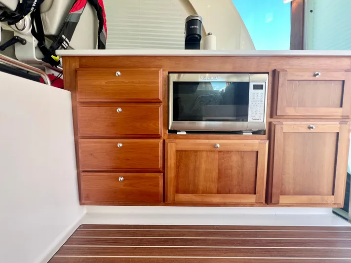 Risk & Reward Yacht Photos Pics Wooden cabinetry with microwave in 2022 Back Cove 39O boat interior.