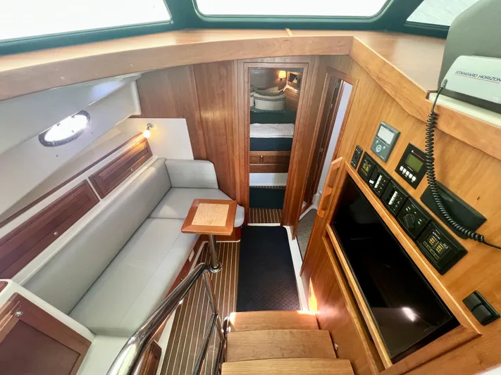 Risk & Reward Yacht Photos Pics 2022 Back Cove 39O interior with wood finish, seating area, and control panel.