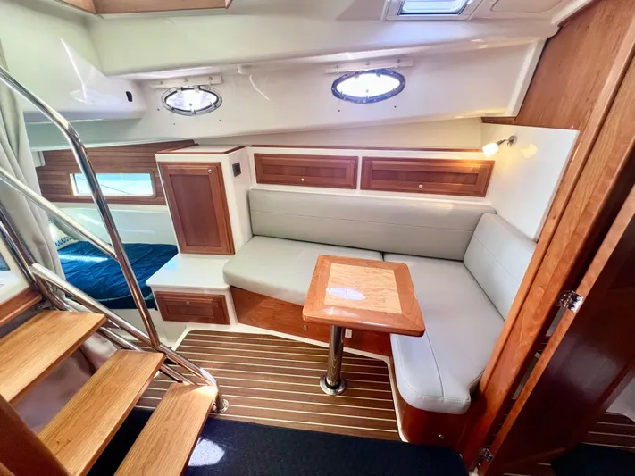 Risk & Reward Yacht Photos Pics Interior of 2022 Back Cove 39O yacht with wooden accents and cozy seating area.