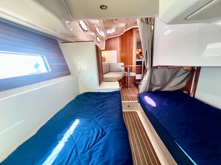 Risk & Reward Yacht Photos Pics 2022 Back Cove 39O cabin interior with twin beds and modern wood finish.