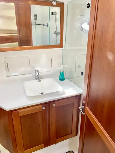 Risk & Reward Yacht Photos Pics 2022 Back Cove 39O yacht bathroom with wooden cabinetry and modern sink.