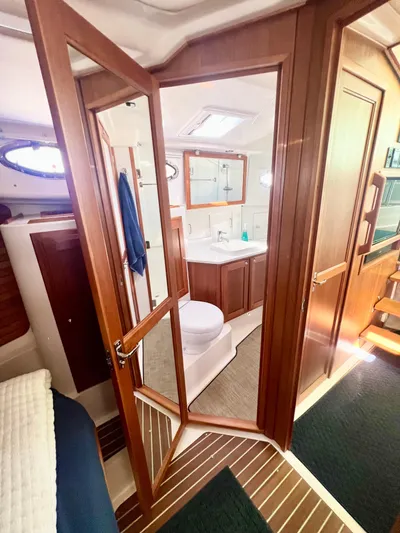 Risk & Reward Yacht Photos Pics Interior of 2022 Back Cove 39O yacht, featuring a modern bathroom with wooden accents.