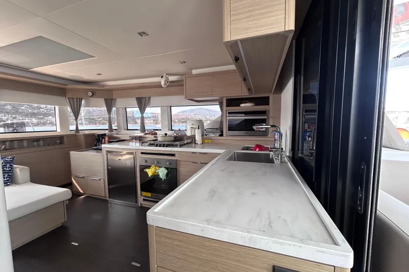 Nani Yacht Photos Pics Modern kitchen interior of 2024 Lagoon 55 yacht with sleek design and ample natural light.