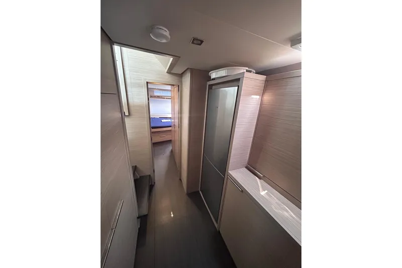 Nani Yacht Photos Pics Interior hallway of 2024 Lagoon 55 yacht, featuring modern wood paneling and sleek design.