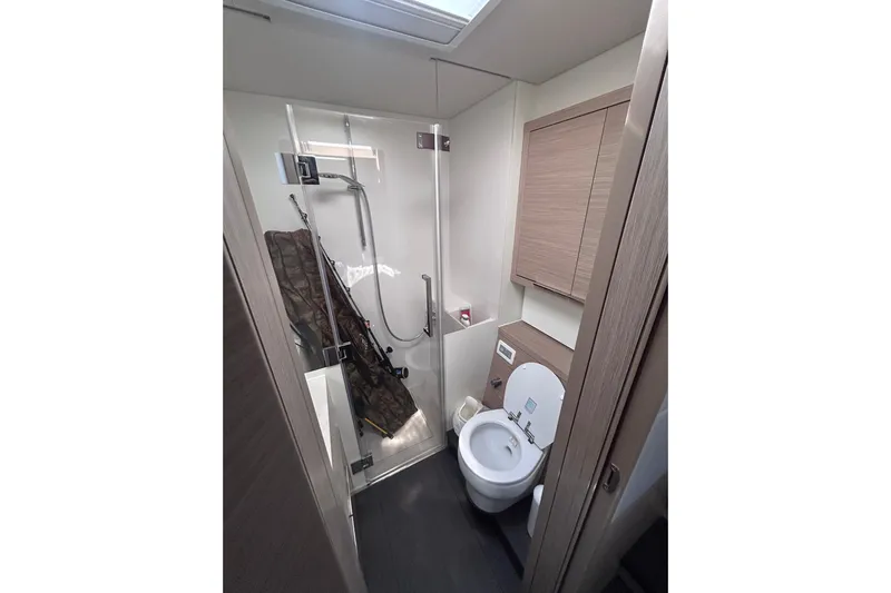 Nani Yacht Photos Pics Modern bathroom in 2024 Lagoon 55 yacht, featuring shower and toilet.