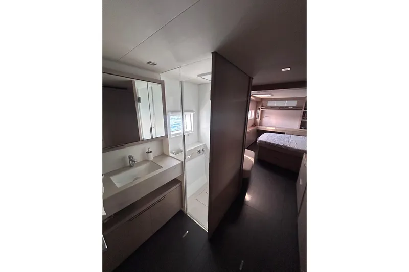 Nani Yacht Photos Pics 2024 Lagoon 55 yacht interior with modern bathroom and cozy bedroom.