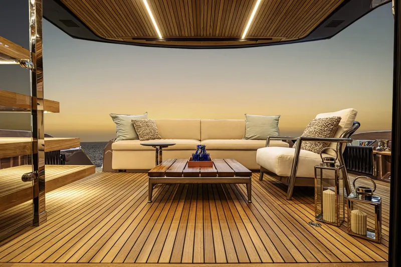  Yacht Photos Pics Luxurious deck of 2025 Cranchi 62 Sessantadue yacht at sunset, featuring elegant seating.