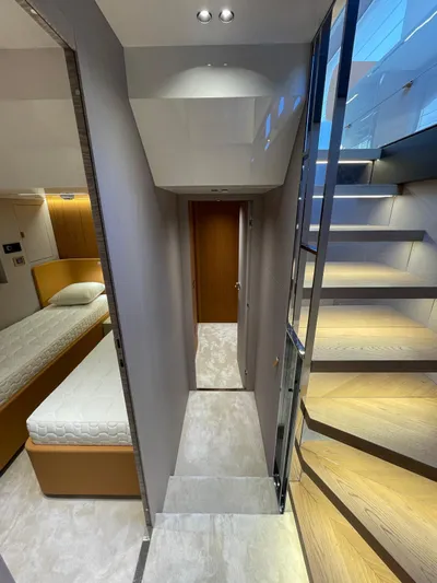  Yacht Photos Pics Interior of 2025 Cranchi 62 Sessantadue yacht, featuring modern staircase and cozy bedroom.
