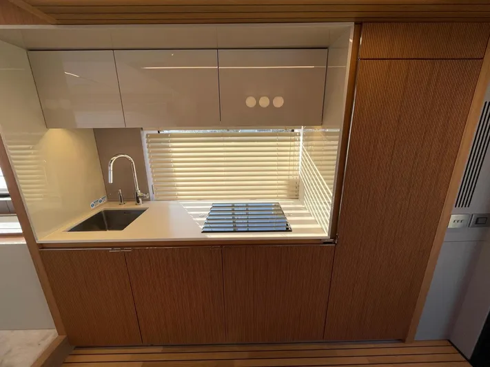  Yacht Photos Pics Modern kitchen in 2025 Cranchi 62 Sessantadue yacht with sleek cabinetry and appliances.