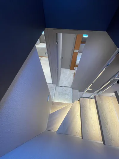  Yacht Photos Pics Interior staircase of 2025 Cranchi 62 Sessantadue yacht, featuring modern design and lighting.