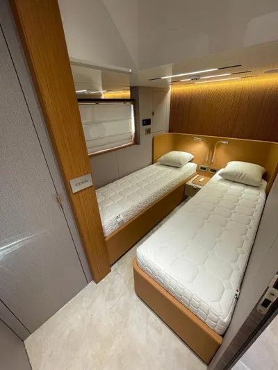  Yacht Photos Pics Luxurious twin cabin in 2025 Cranchi 62 Sessantadue yacht, featuring modern design and cozy beds.