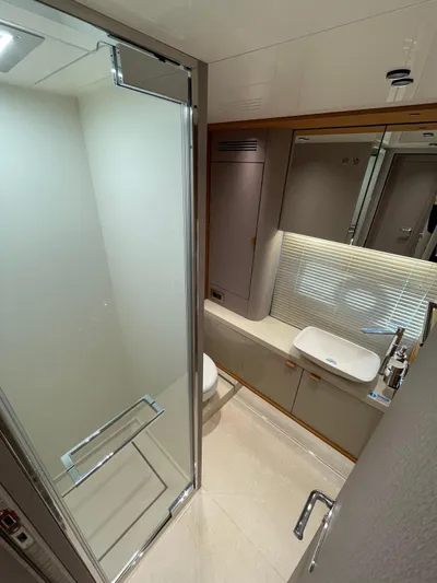  Yacht Photos Pics Luxurious bathroom in 2025 Cranchi 62 Sessantadue yacht with modern fixtures and glass shower.