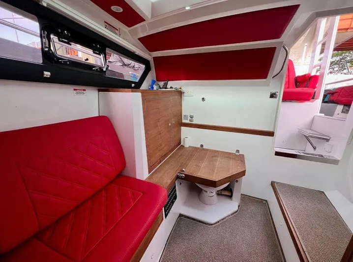  Yacht Photos Pics Interior of 2018 Axopar 37 Sun-Top with red seating and wooden accents.