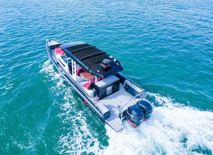  Yacht Photos Pics 2018 Axopar 37 Sun-Top cruising on clear blue water, aerial view.