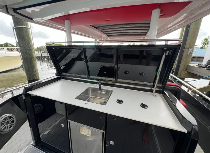  Yacht Photos Pics 2018 Axopar 37 Sun-Top boat with outdoor kitchenette and sink.