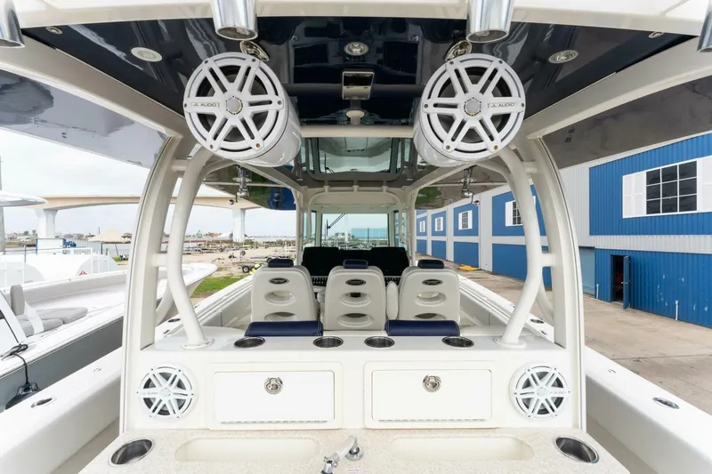  Yacht Photos Pics 2018 Hydra-Sports 4200 Siesta boat interior with speakers and seating, docked near blue buildings.