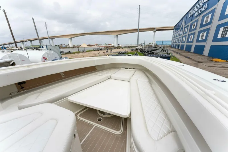  Yacht Photos Pics 2018 Hydra-Sports 4200 Siesta boat interior with white seating and table, docked at marina.