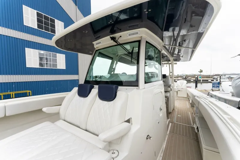  Yacht Photos Pics 2018 Hydra-Sports 4200 Siesta boat with sleek design, docked near a blue building.