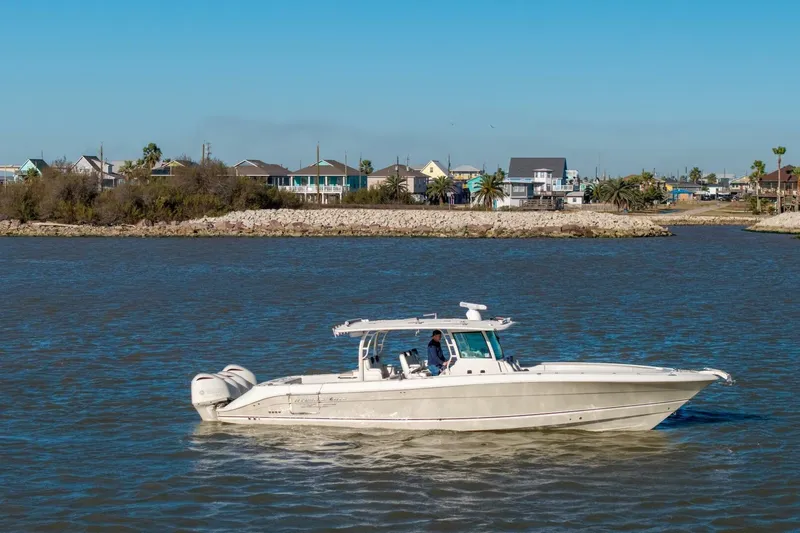  Yacht Photos Pics 2018 Hydra-Sports 4200 Siesta boat cruising on a calm river near a residential shoreline.